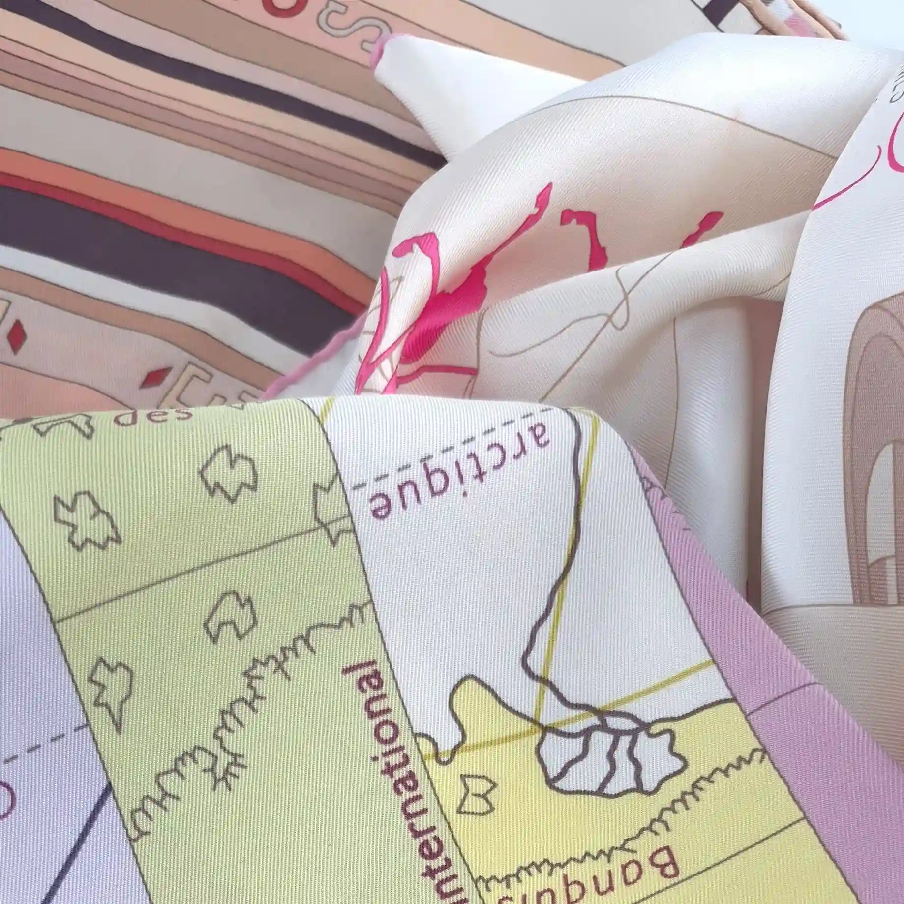 collection of vintage hermes silk scarves flat lay