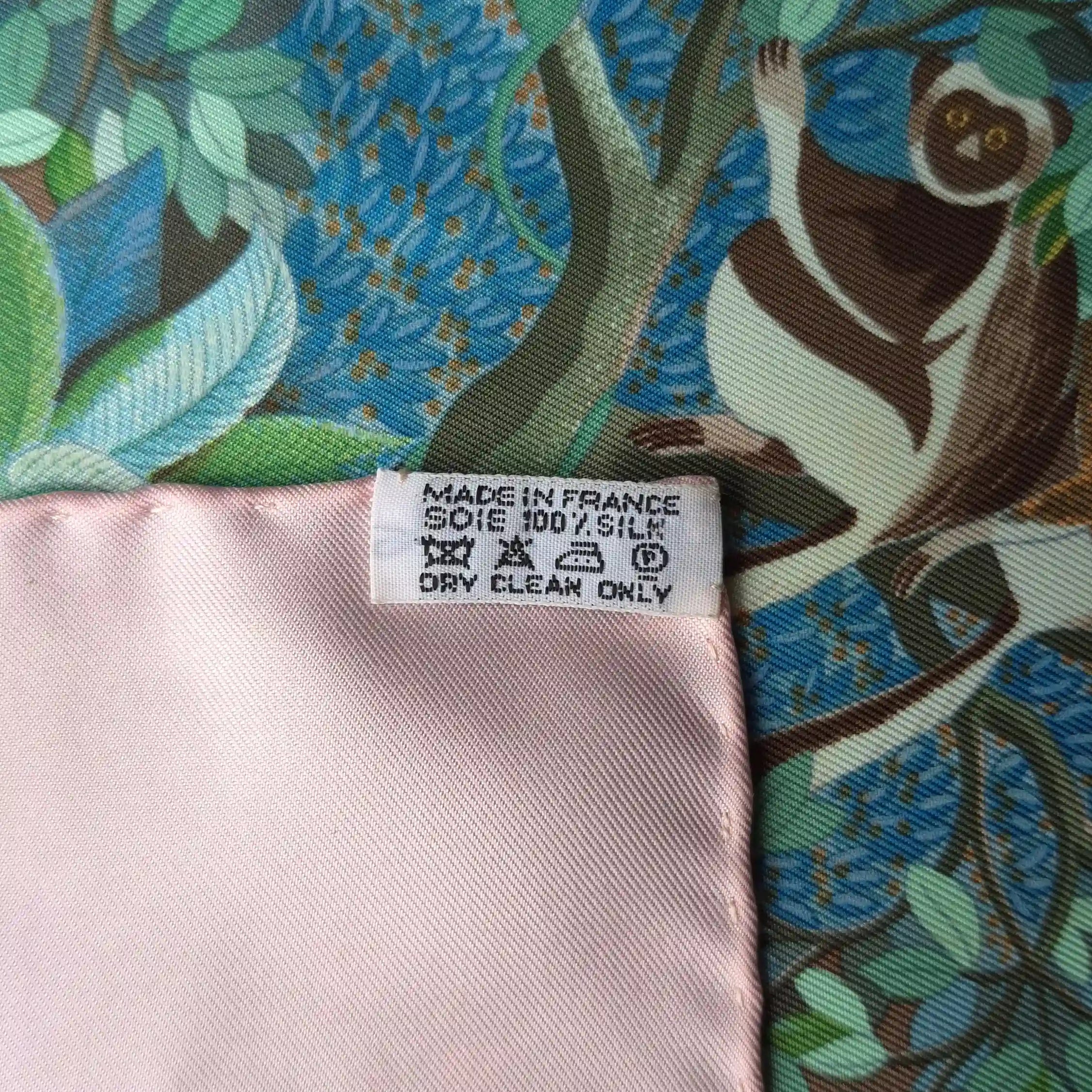Hermès Au Cœur de la Vie silk scarf by Aline Honoré – pink and celadon colorway – lush botanical pattern with exotic birds, tropical foliage and central medallion detail