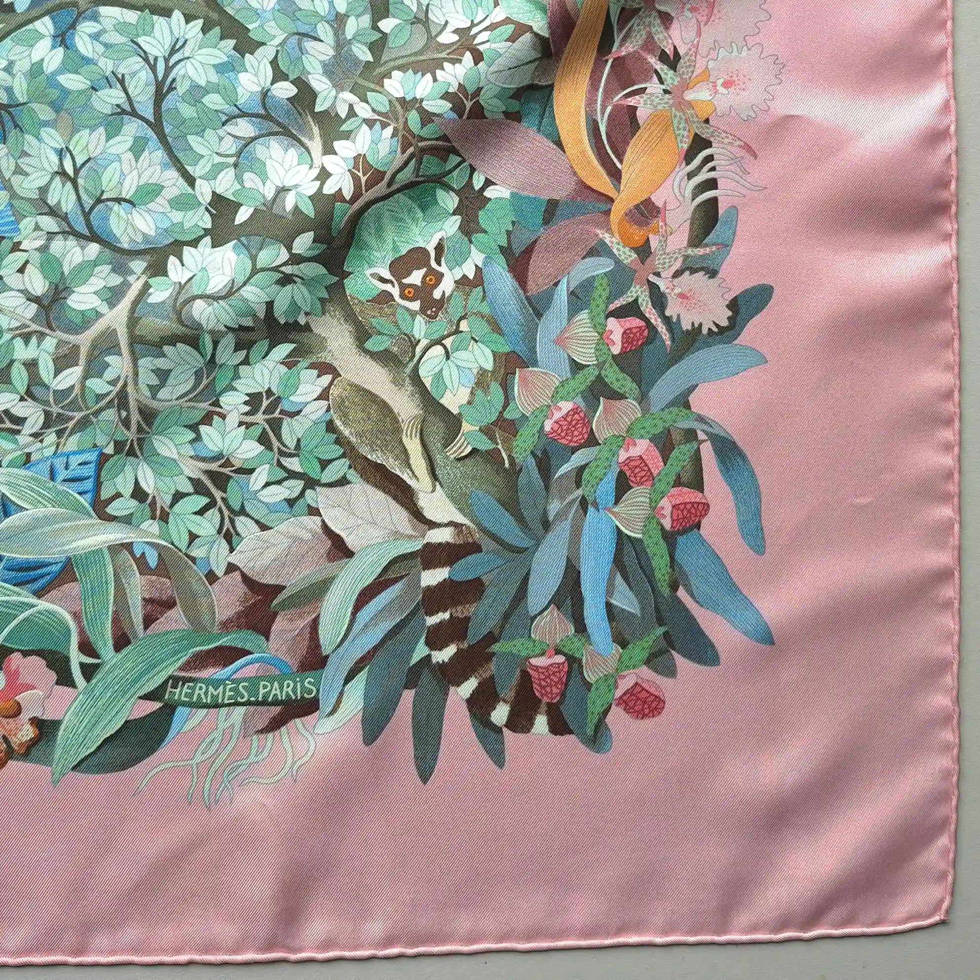Hermès Au Cœur de la Vie silk scarf by Aline Honoré – pink and celadon colorway – lush botanical pattern with exotic birds, tropical foliage and central medallion detail