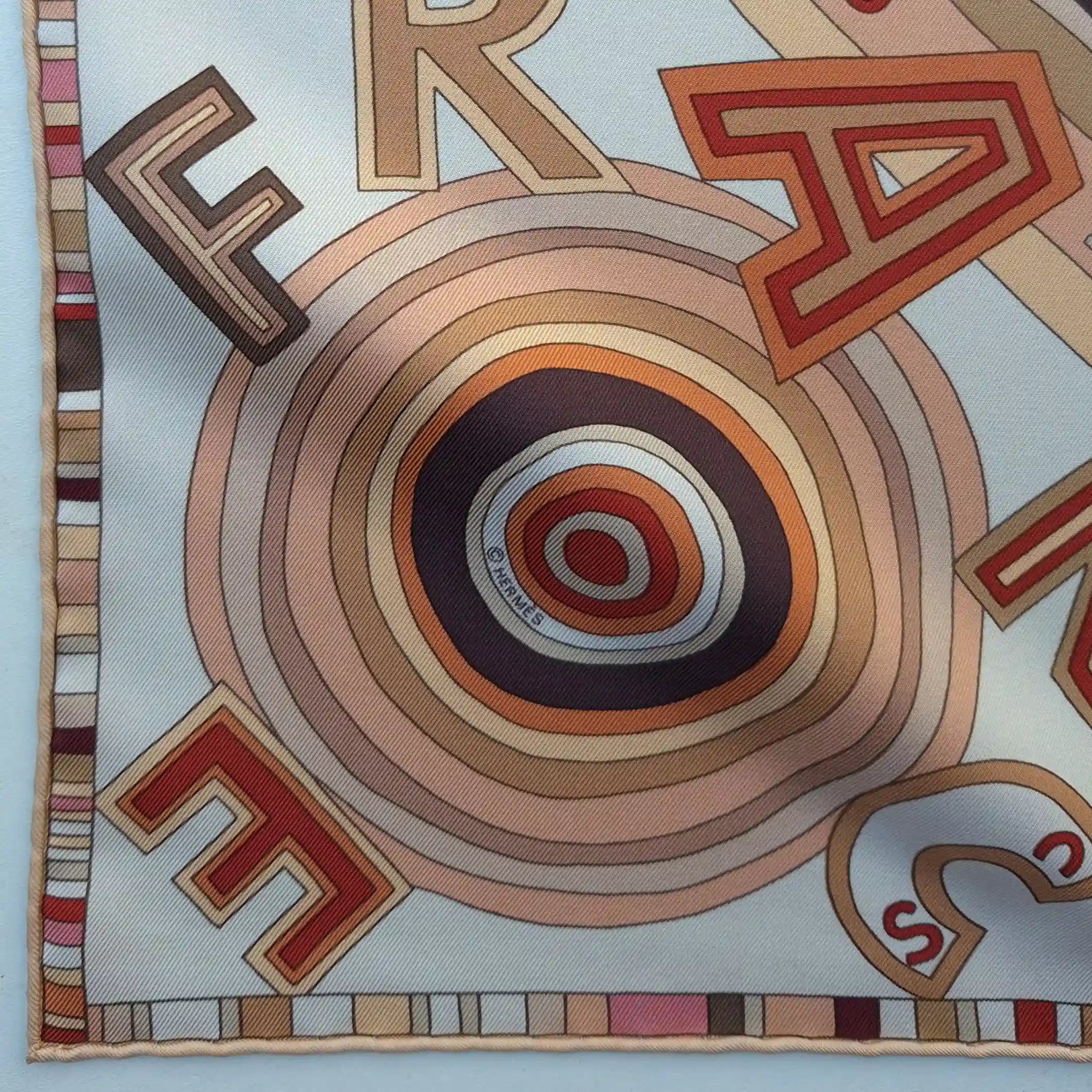 hermes tohu bohu claudia stuhlhofer mayr silk scarf beige red concentric typography detail